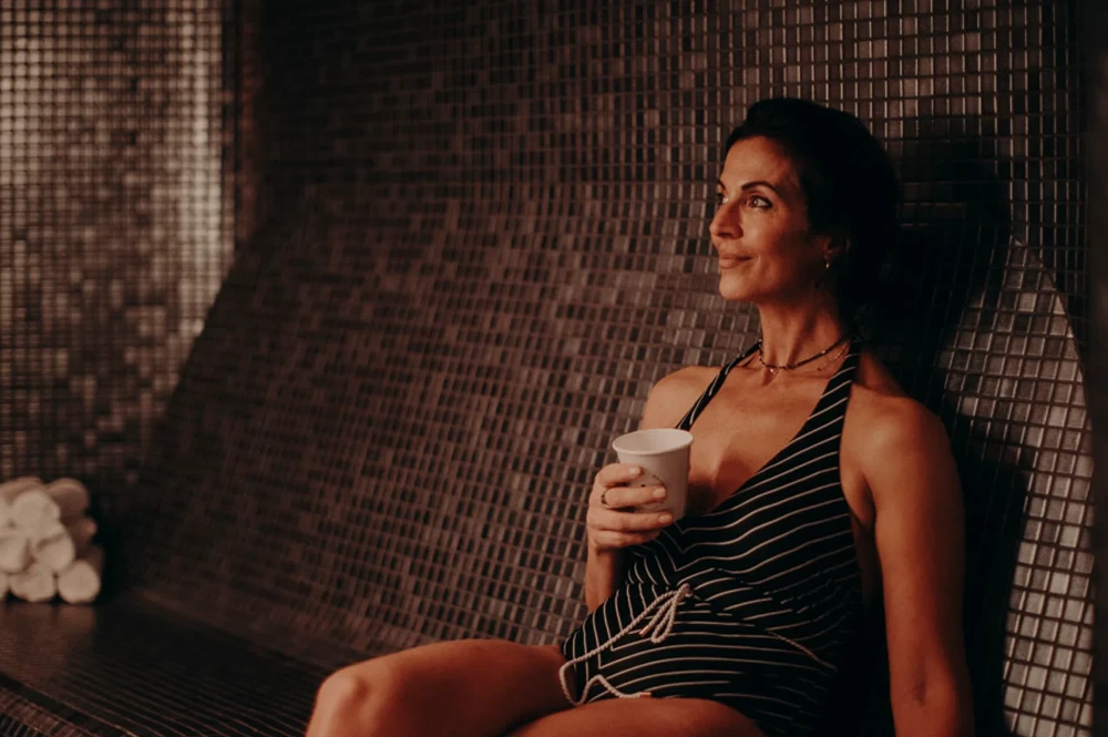 Woman sitting in Aurora Batthouse