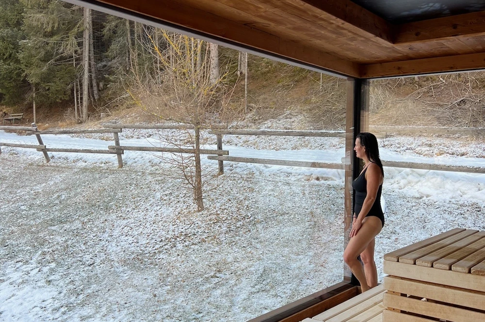 Woman enjoying Bathhouse snow covered background